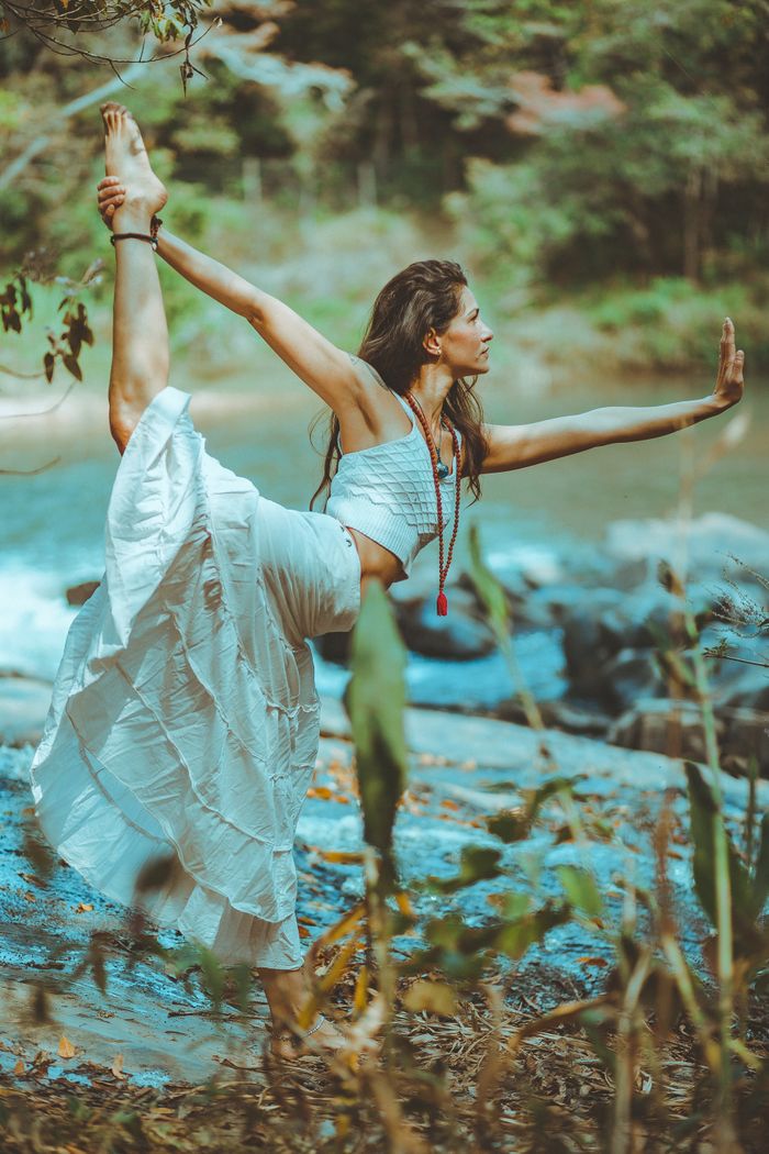 why-choose-us-02 A serene scene of a woman practicing yoga by a picturesque river shore, embodying balance and tranquility.